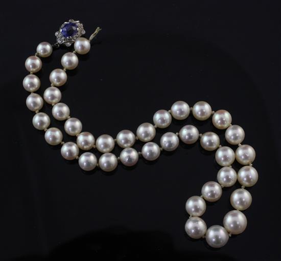 A single strand graduated cultured pearl necklace with sapphire and diamond cluster clasp, 14.5in.